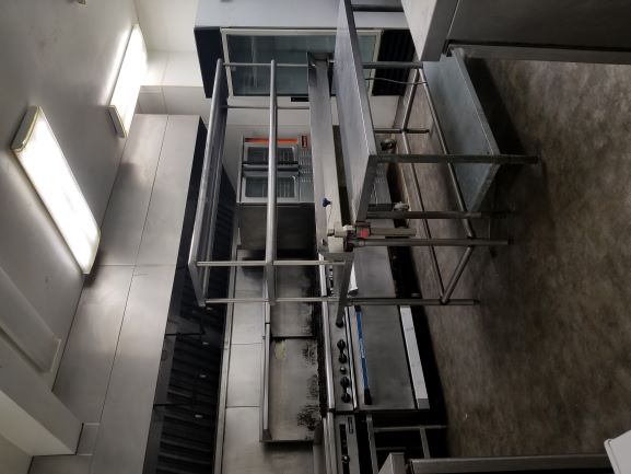 Brookhaven commercial kitchen with stainless prep tables and hood