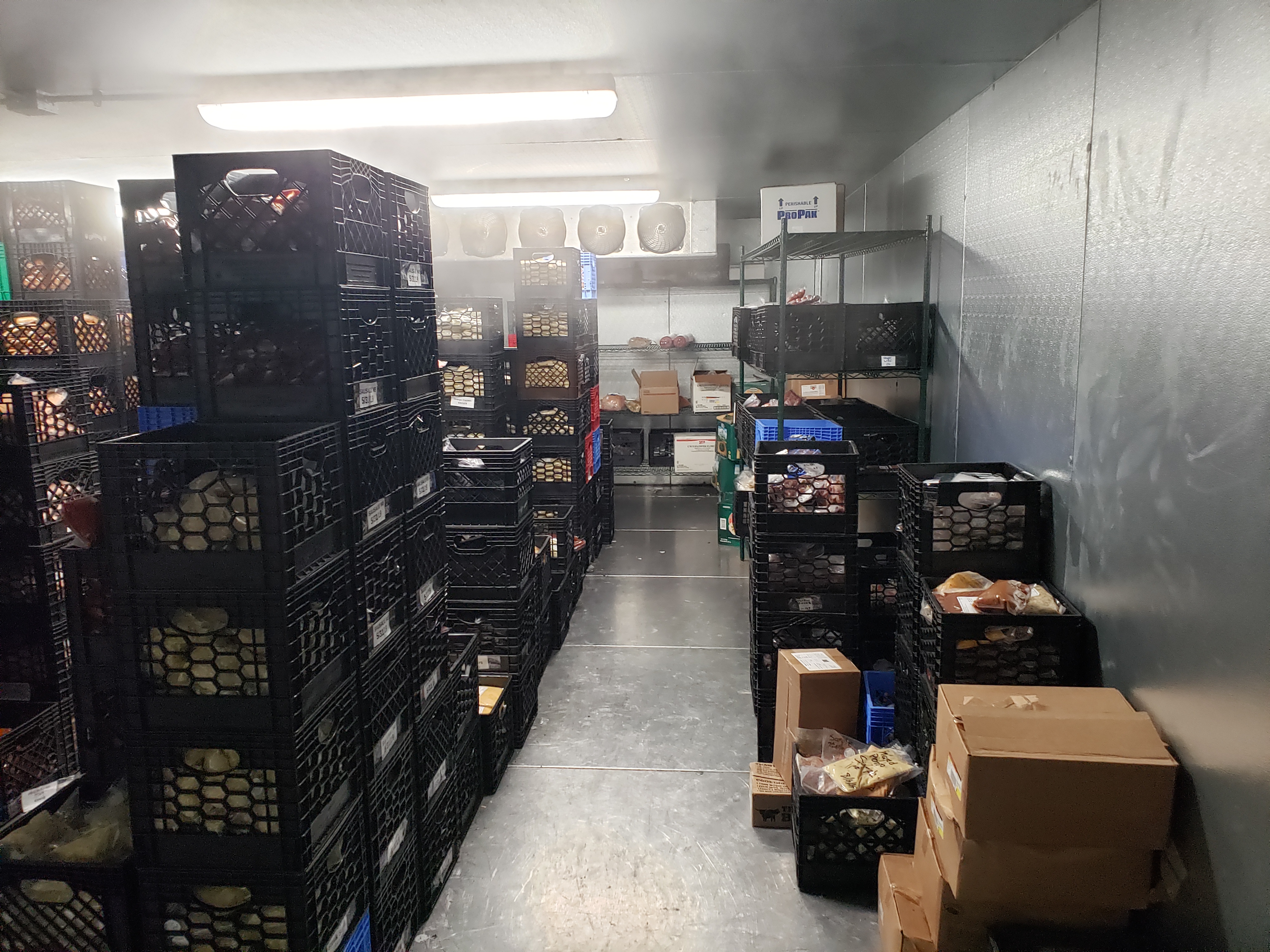 Walk-in freezer with storage racks documented at the Brookhaven property